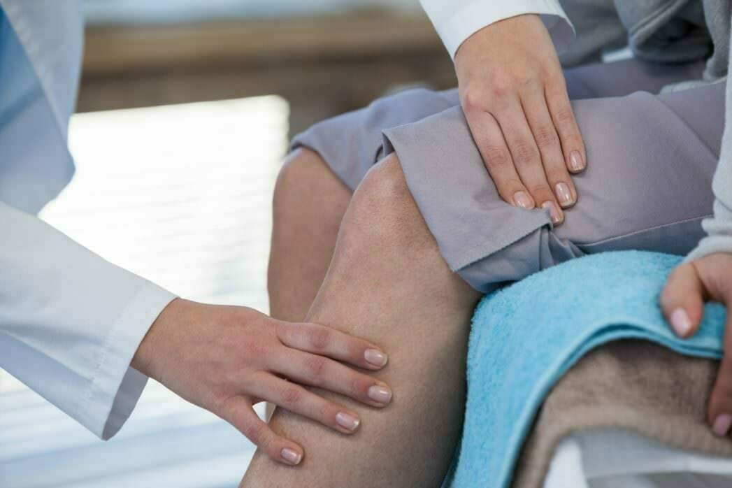 Physical Therapist examining knee